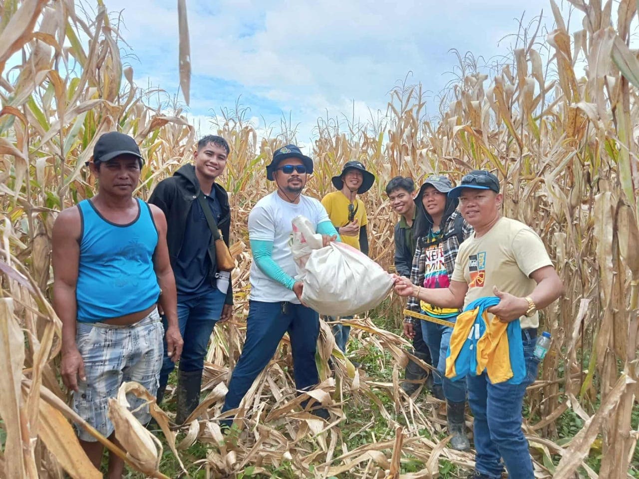 Farmers and NatureTech team at a corn harvest